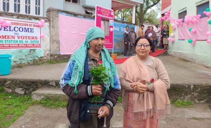 Meenakshi Devi and Mool Raj Mishr were presented flowers by the polling staff after they become the first voter to cast their votes at Pink polling station and PS 44 respectively in Bhaderwah. -Excelsior/Tilak Raj