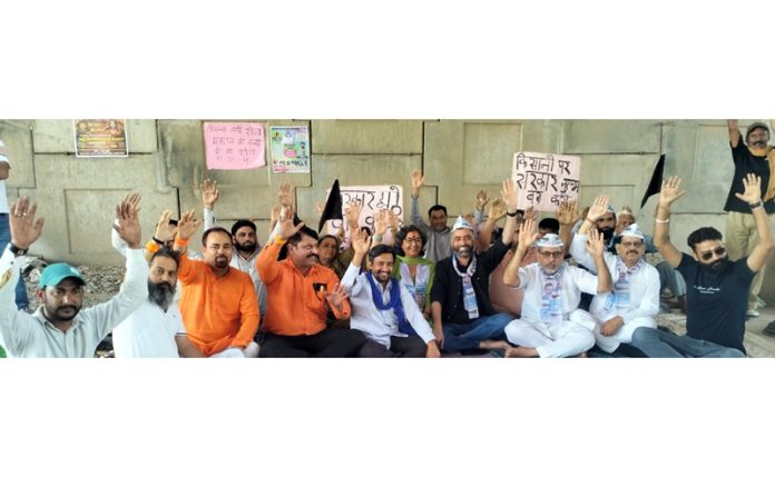 Leaders of Shiv Sena, AAP and others raising slogans during a protest demonstration at Jammu on Sunday.