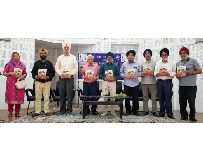 Dignitaries releasing a Punjabi book at Jammu on Saturday.