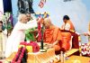 A devotee garlanding Swami Govind Dev Giri Ji Maharaj during a programme in Haridwar on Monday.