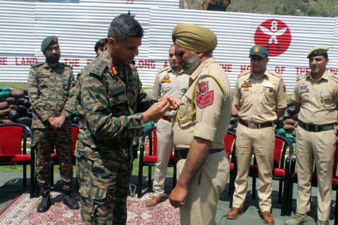 GOC-in-C, Northern Command, conferring an award on JKP HC Agya Singh at Buddhal area of Rajouri District on Monday.