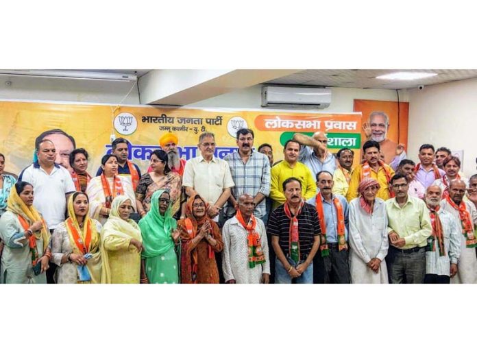 Senior BJP leader Kavinder Gupta along with the people who joined the party in Jammu on Monday.