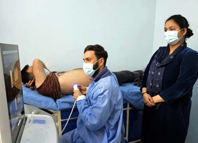 Technician busy in carrying out fibroscan of a patient at GMC Baramulla. -Excelsior/Aabid Nabi