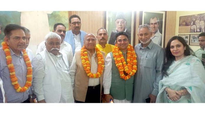 Engineer Vikram Puri posing with senior NC leaders after joining the party at Sher-e-Kashmir Bhavan, Jammu.