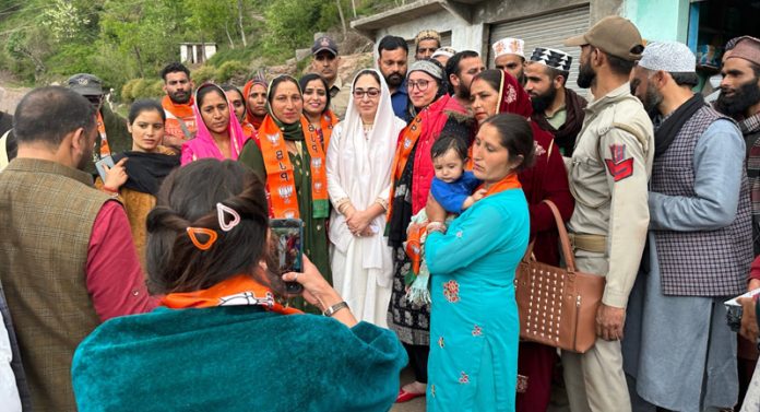 BJP National executive member and Chairperson of J&K Waqf Board Dr Syed Darakhshan Andrabi posing with locals at Mahore, Reasi.
