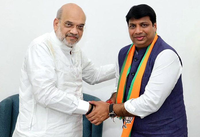 Union Home Minister Amit Shah with newly-joined BJP leader Rohan Gupta at a meeting in New Delhi on Thursday. (UNI)