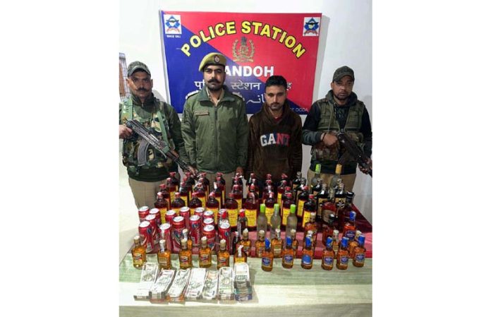Cops displaying cash and liquor along with the person from whom it was seized in Gandoh on Friday.