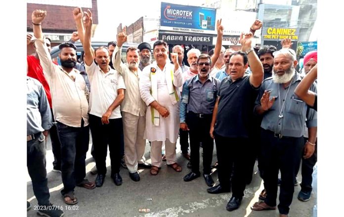 Drivers and owners of black autos raising slogans during a protest demonstration in Jammu on Sunday.