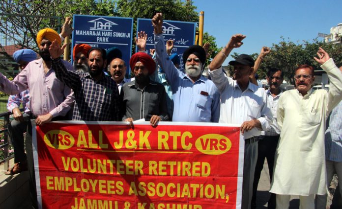 Retired JKRTC employees holding protest near Maharaja Hari Singh Park in Jammu on Saturday.