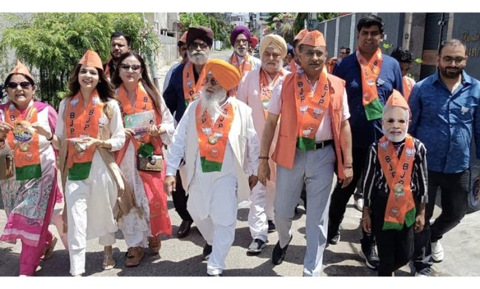 BJP leaders during door to door campaign in Jammu on Sunday.