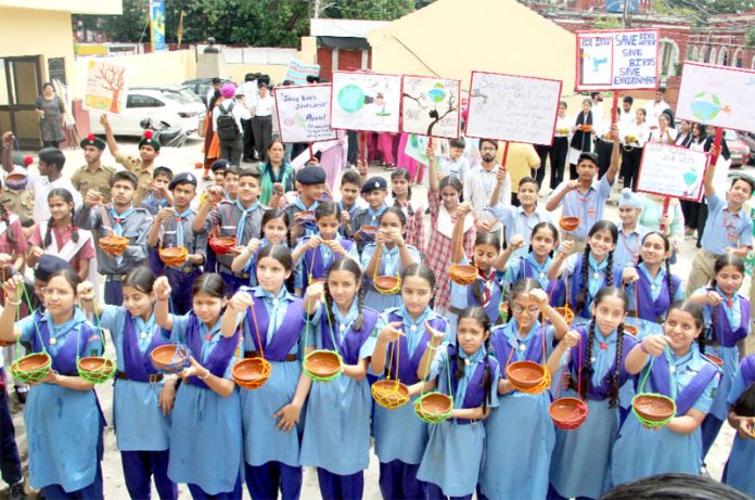 Children drawn from various schools holding 'hang pots' in their hands during an event at Dogra Sadar Sabha Bhawan, Jammu on Saturday. -Excelsior/Rakesh