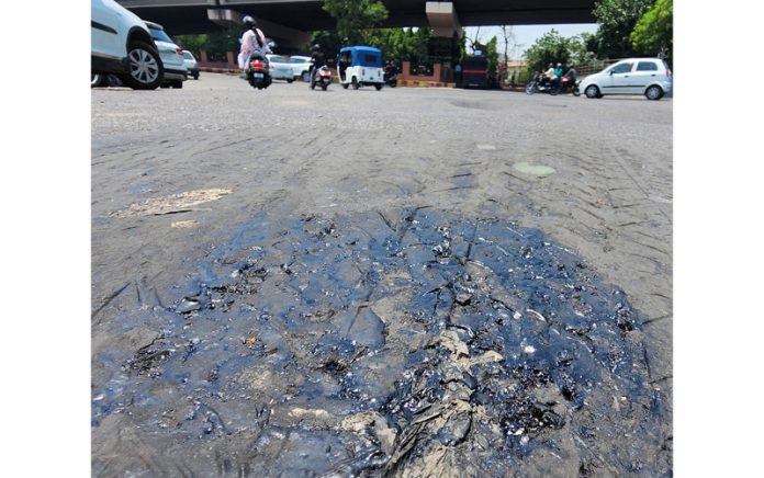 Tarcoal melts on a Jammu city road on a hot summer day. -Excelsior/Rakesh