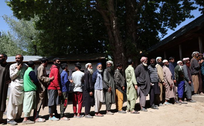 Tribal voters line up to cast votes in Daksum area of Anantnag on Saturday. -Excelsior/Shakeel