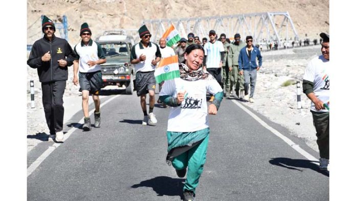 A woman taking part in a run organized by Army in Leh on the eve of Kargil Vijay Diwas.