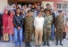 Brigadier Deepak Sajanhar posing for a group photograph with students of GDC Kargil and others.