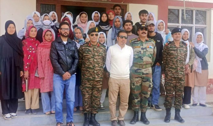 Brigadier Deepak Sajanhar posing for a group photograph with students of GDC Kargil and others.