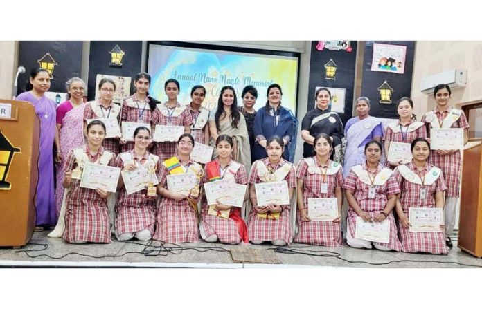 Students displaying certificates while posing with dignitaries during debate competition on Tuesday. 