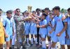 Chief Guest presenting trophy to winning team of APS Samba.