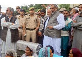 Relatives protest with dead body of deceased on Rajouri-Thanna Road on Sunday.