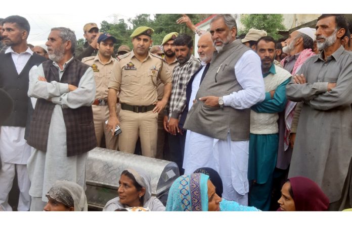 Relatives protest with dead body of deceased on Rajouri-Thanna Road on Sunday.