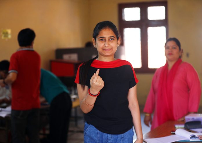 A migrant voter displays ink mark after casting vote in Jammu. -Excelsior/Rakesh