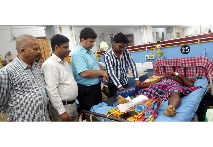 BJP leader, Puneet Mahajan taking on spot initiative to reactivate the Ayushman Card of a patient undergoing treatment at GMC, Jammu on Wednesday.