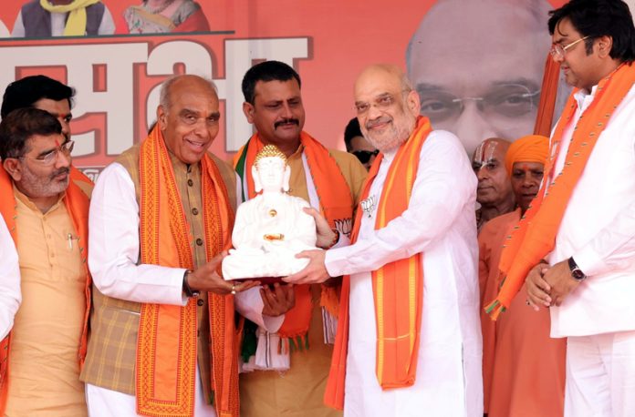 Home Minister Amit Shah being felicitated at a public meeting for Lok Sabha elections in Uttar Pradesh on Thursday. (UNI)