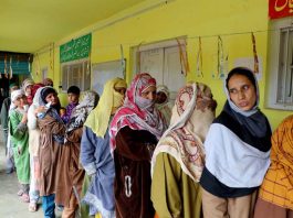 Women line up to exercise their right to franchise outside Tahab Polling Station in Pulwama on Monday. -Excelsior/Younis Khaliq