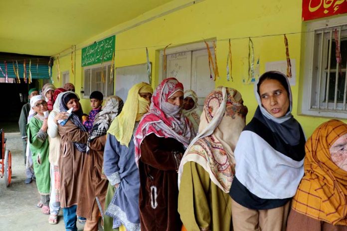 Women line up to exercise their right to franchise outside Tahab Polling Station in Pulwama on Monday. -Excelsior/Younis Khaliq