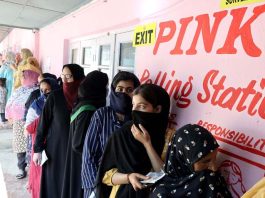 Female voters stand in line to cast their votes at a Pink Polling Station in Bemina area of Budgam. -Excelsior/Shakeel
