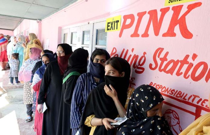 Female voters stand in line to cast their votes at a Pink Polling Station in Bemina area of Budgam. -Excelsior/Shakeel
