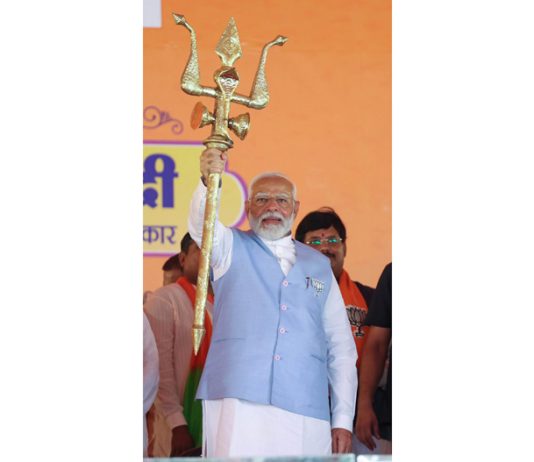 Prime Minister Narendra Modi holds a trident at a public meeting in Uttar Pradesh on Friday. (UNI)