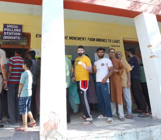 Migrant voters waiting in a queue in front of a Special Polling Booth at Jammu on Monday. Excelsior/Rakesh