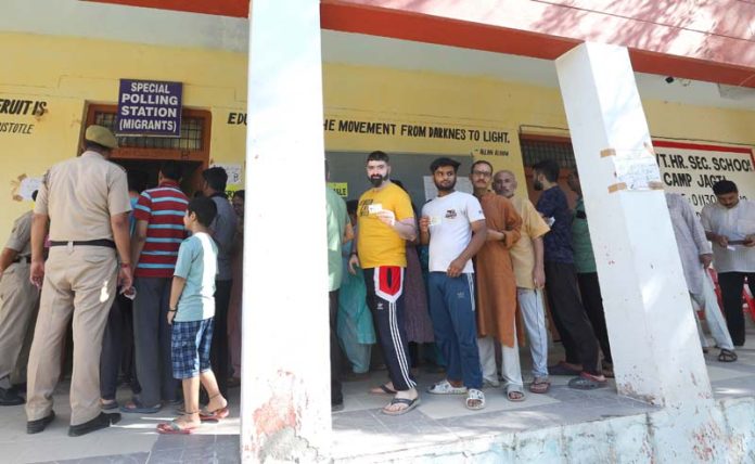 Migrant voters waiting in a queue in front of a Special Polling Booth at Jammu on Monday. Excelsior/Rakesh