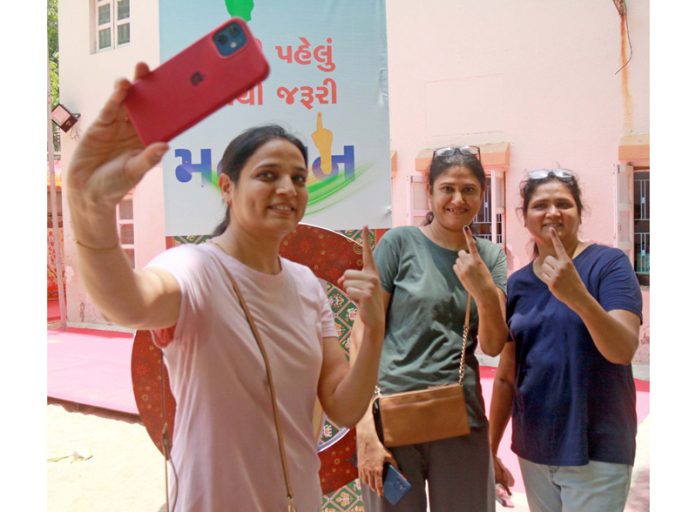 Girls taking selfie after casting their vote at a polling station during the 3rd phase of Lok Sabha elections, in Ahmedabad on Tuesday. Another pic on page 4. (UNI)