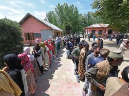 People wait in long queues to cast their votes in Shalabugh area at Srinagar on Monday. -Excelsior/Shakeel