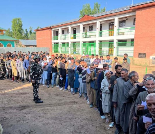 Voters waiting in queue to cast their votes at Pattan in Baramulla district. -Excelsior/Abid Nabi