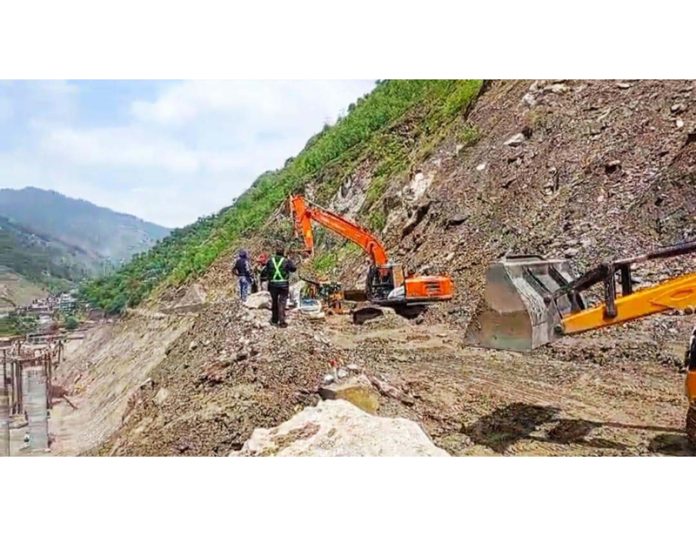 Men and machinery at work as Jammu-Srinagar National Highway remains blocked for second day on Tuesday in Ramban district. -Excelsior/Parvaiz