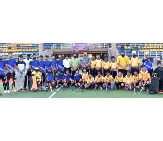 Participating players in six day Men Jammu Hockey League 2024 pose for a group photograph with others on Saturday.