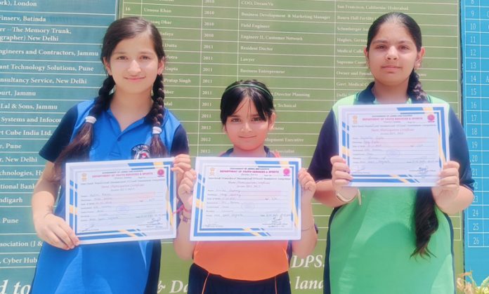 Winners of Inter-Zonal level Chess competition displaying certificates while posing for group photograph in Jammu on Wednesday.