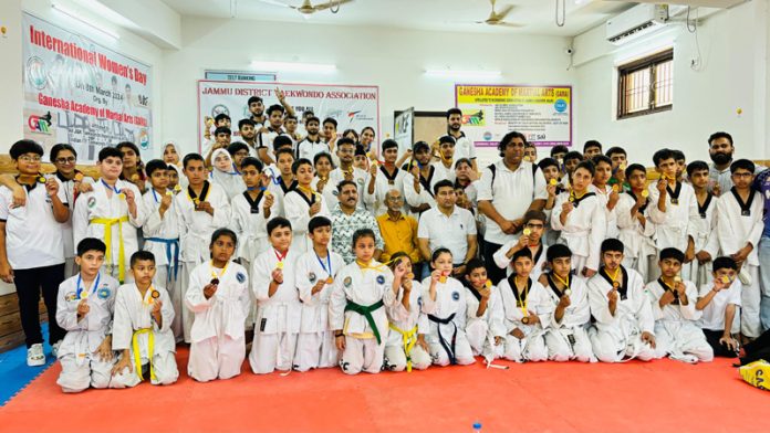 Taekwondo players posing along with dignitaries during an event at Jammu.