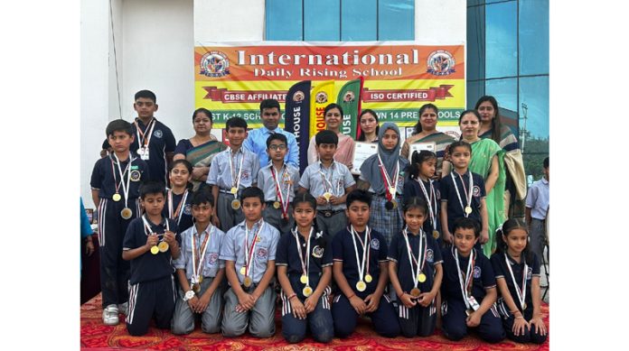 Students posing along with Chief Guest and school management during a programme on Friday.