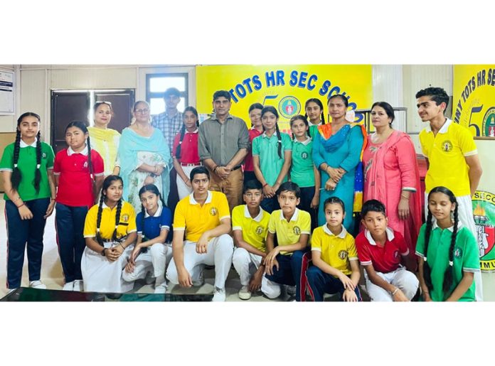 Junior and senior debaters posing for group photograph during debate competition at Tiny Tots Hr Sec School, Sainik Colony, Jammu on Monday.