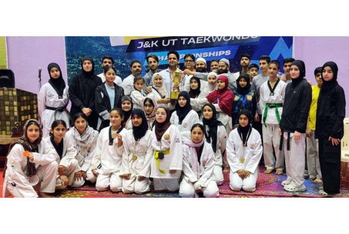 Dignitaries presenting trophy to a winning team during concluding day of Chenab Open J&K-UT Taekwondo Championships at Doda.