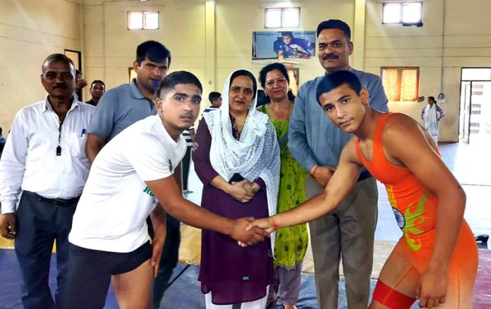 Wrestlers shaking hands after a bout at Indoor Stadium, Akhnoor in Jammu.