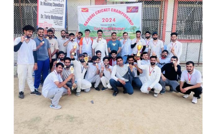 Participating players of Rajouri Cricket Championship along with others pose for a group photograph at a Stadium in Rajouri.