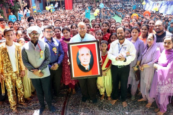 Dignitaries posing alongwith picture of Late Dev Dutt Mengi, Founder Principal of Shiksha Niketan.