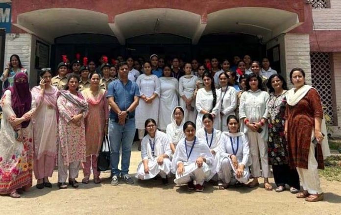 Students posing along with dignitaries at GCW Gandhi Nagar.