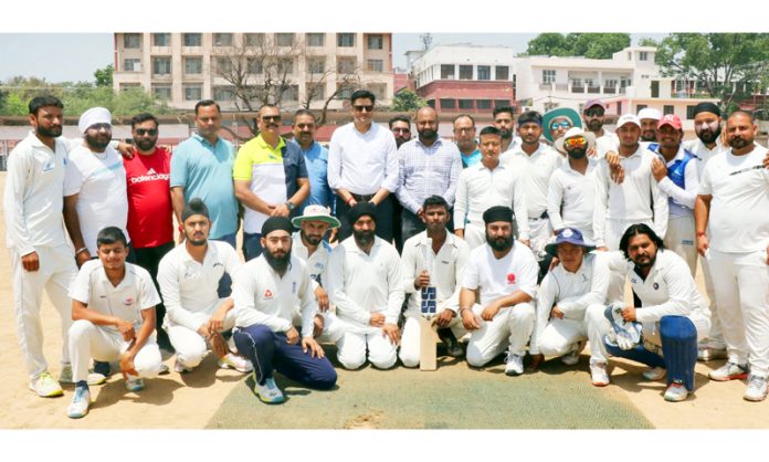 Cricket team posing along with dignitaries on second day of Ashok Sodhi Memorial T-20 Cricket Tournament at Jammu.