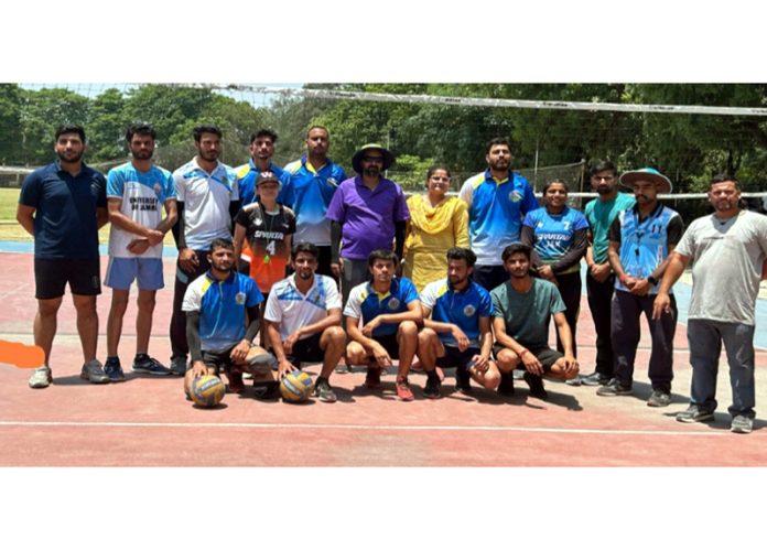 Volleyball team of Department of Sports and Physical Education JU posing along with dignitaries.